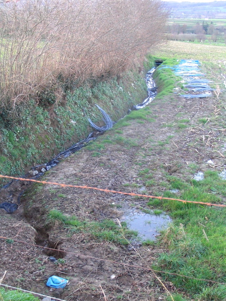 Une petite bâche et le remplissage peut être réalisé (Mars 2007). Le ruisseau traverse une parcelle jusqu'à la route sans être visible